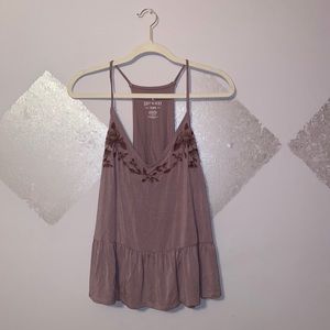 A dark lilac top with floral embroidery on collar